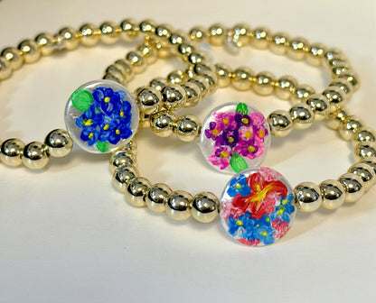 Bracelet with gold beads and colorful hand painted pearls.